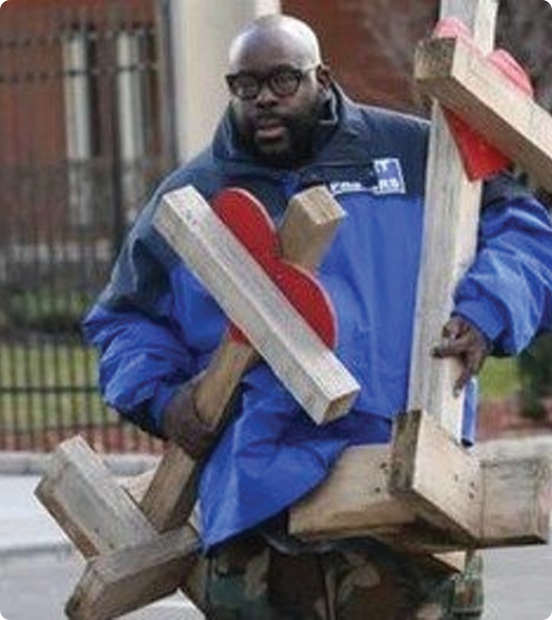 A scene from SnR’s existing website showing memorial crosses being carried during community work.